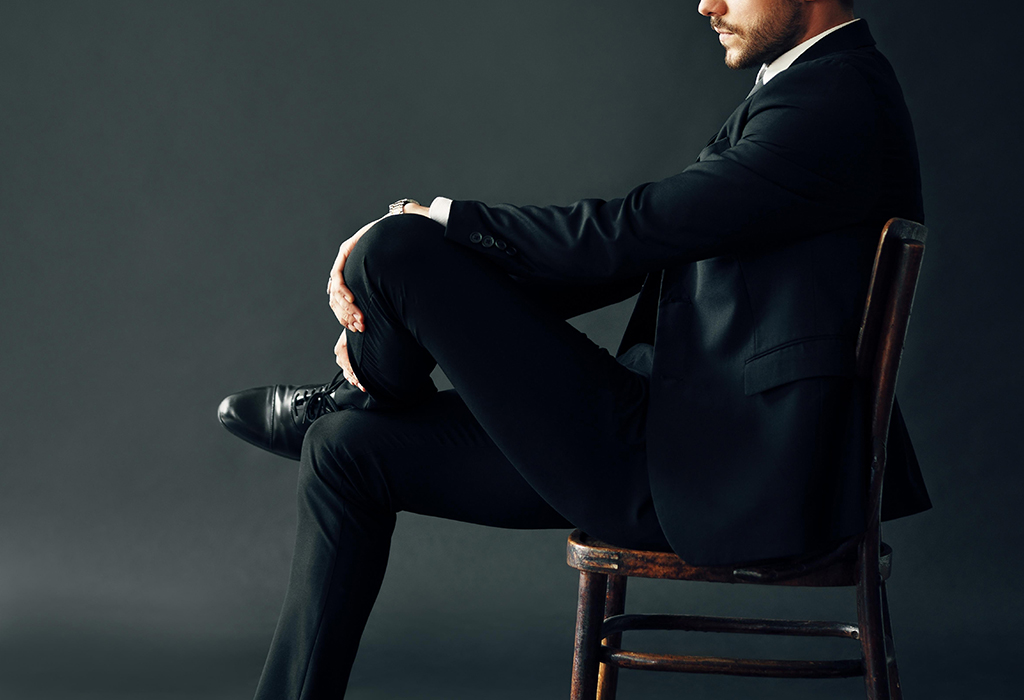 man sitting in a pose projecting higher status