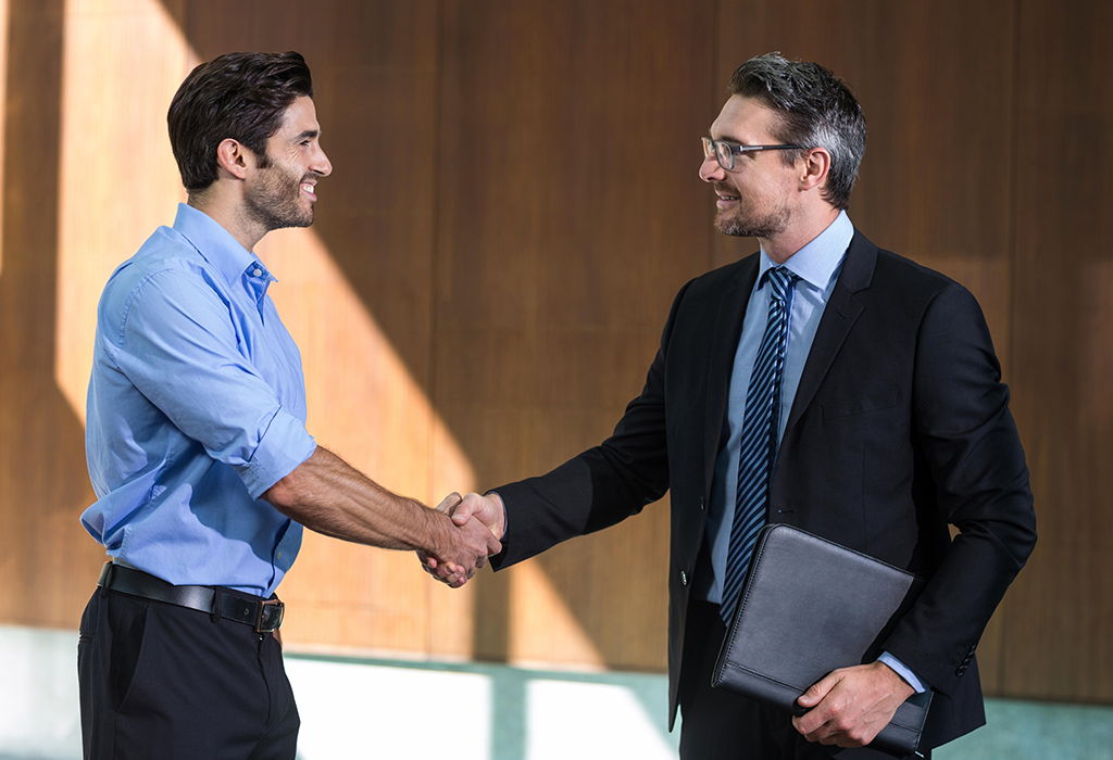 men exchanging good handshake and eye contact