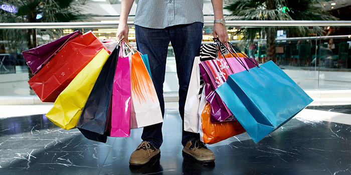 man with a lot of shopping bags