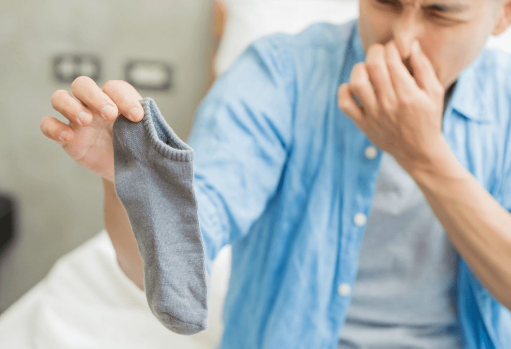 Man holding smelly sock 