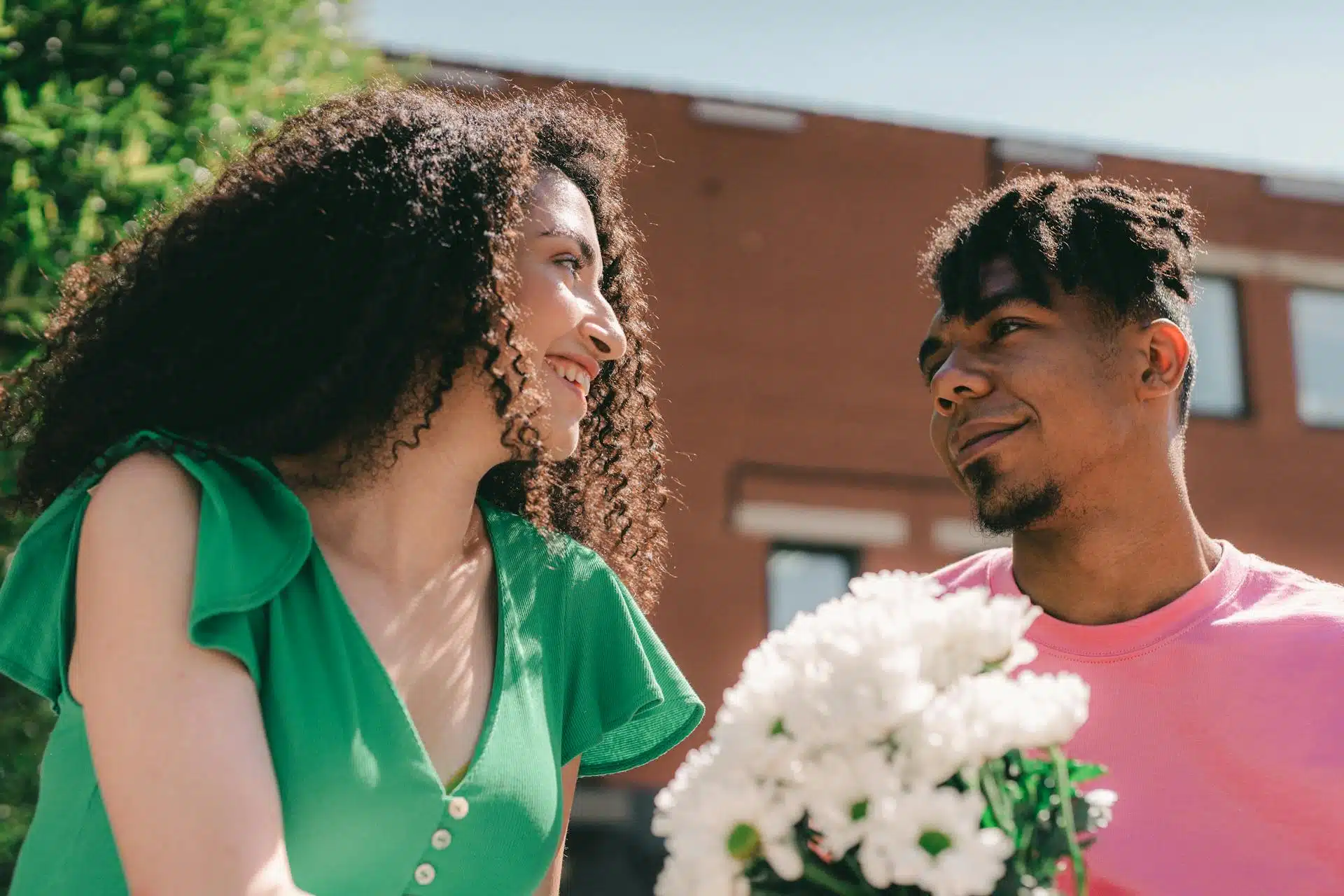A loving couple smiling and looking at each other.