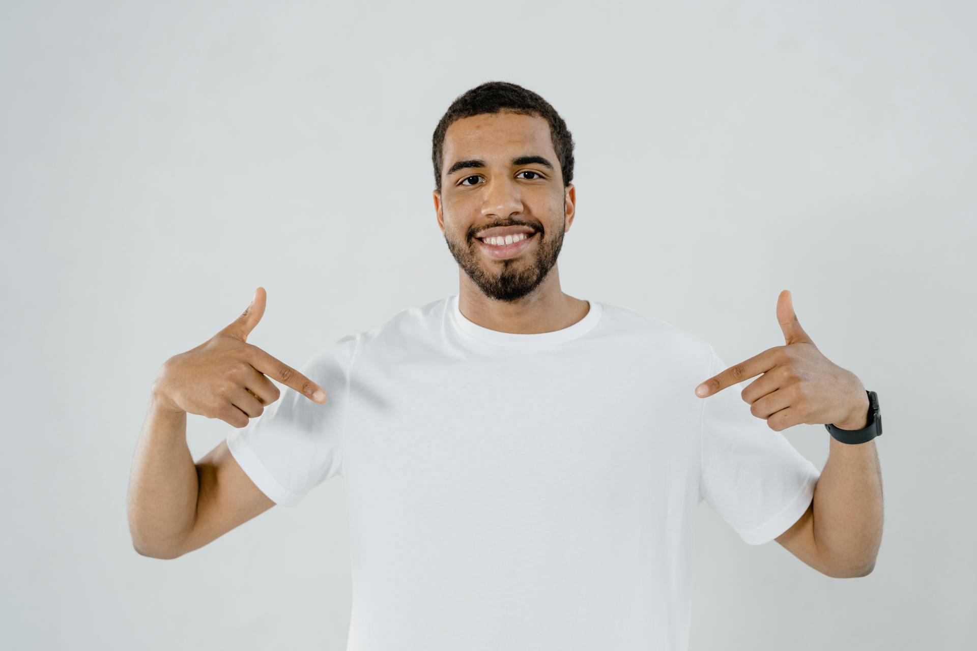 Man Pointing at His Plain White Shirt