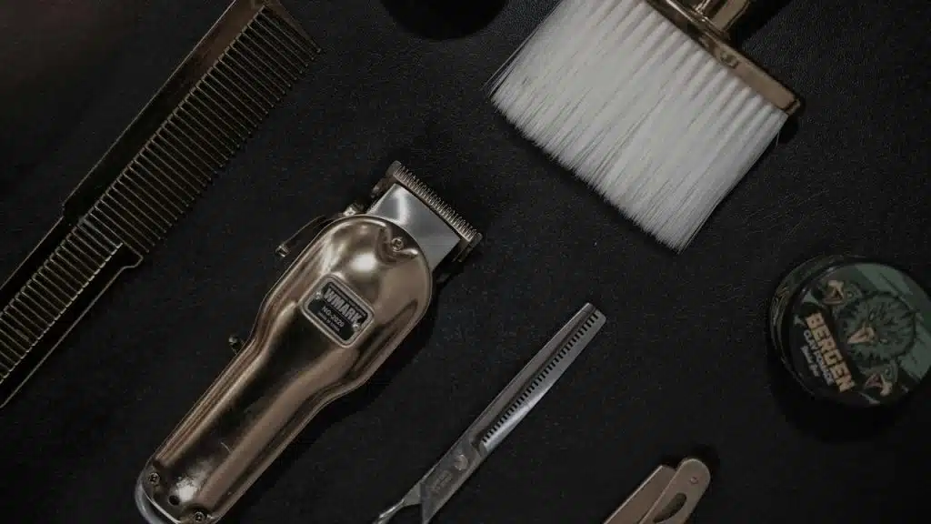Men's grooming tools arranged neatly on a black surface.