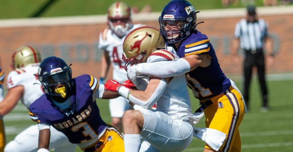 American football player tackling an opponent during a game.