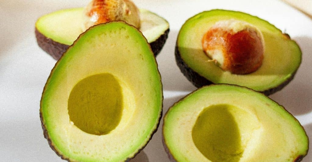 Two Sliced Avocados on a Plate.