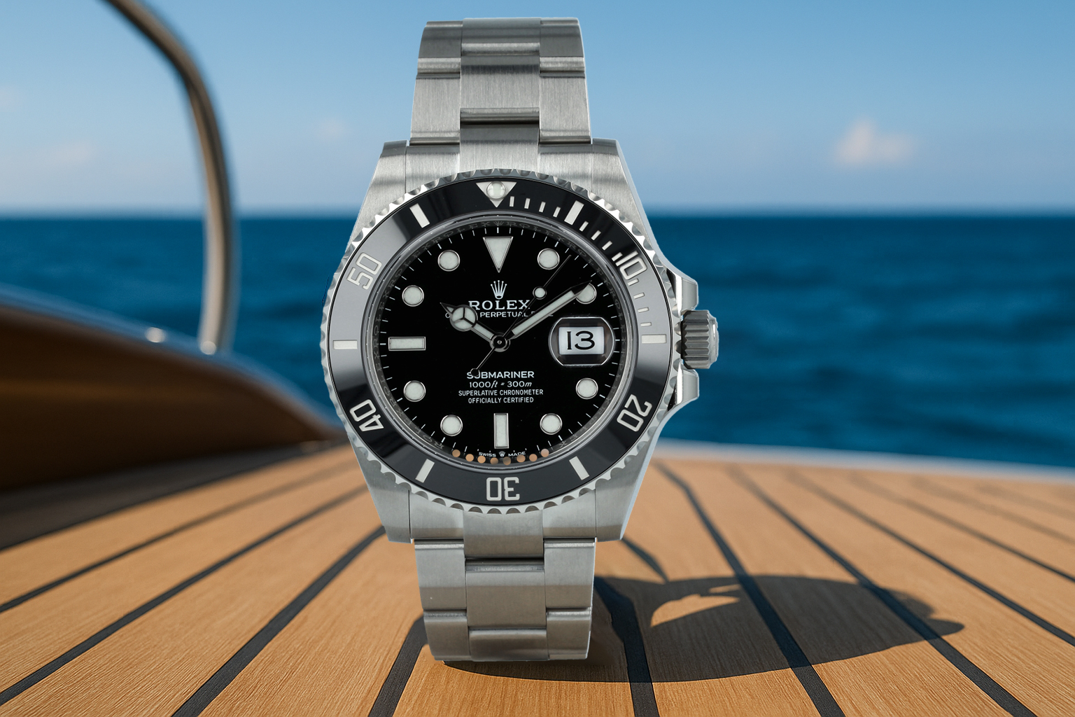 Rolex Submariner with a black dial and bezel, photographed on a yacht deck against a deep blue ocean backdrop.