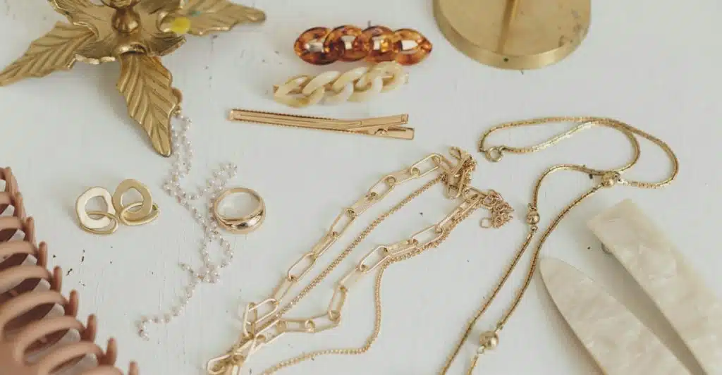 Various jewelry and hair accessories arranged on a white surface.