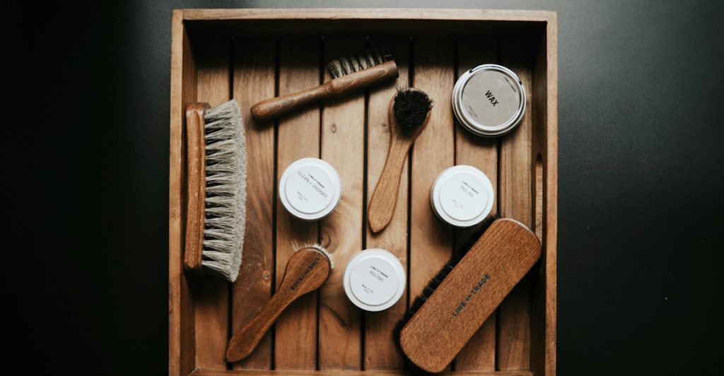 Grooming tools neatly arranged in a wooden tray.
