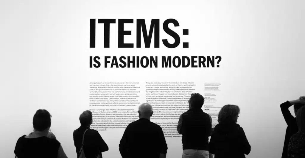 People standing in front of a display with the text "ITEMS: IS FASHION MODERN?".