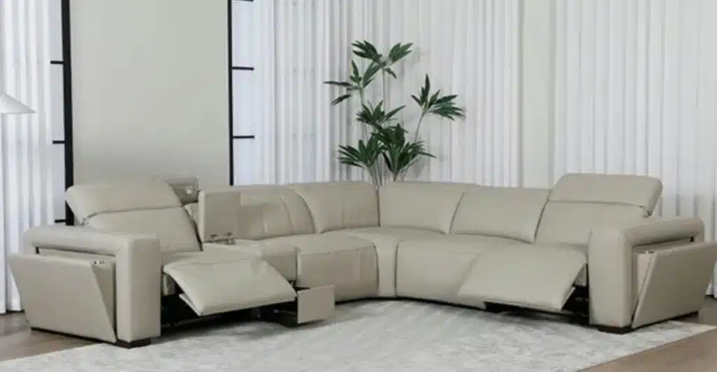 A modern, light-colored sectional sofa in a living room.