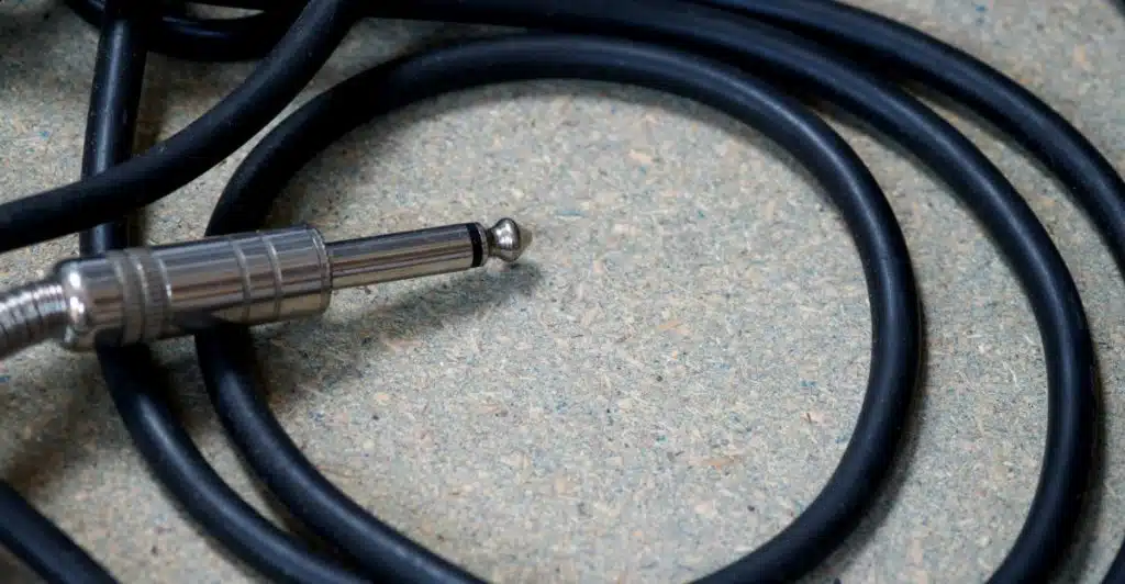 A close-up shot of tangled black cables and a metal connector.