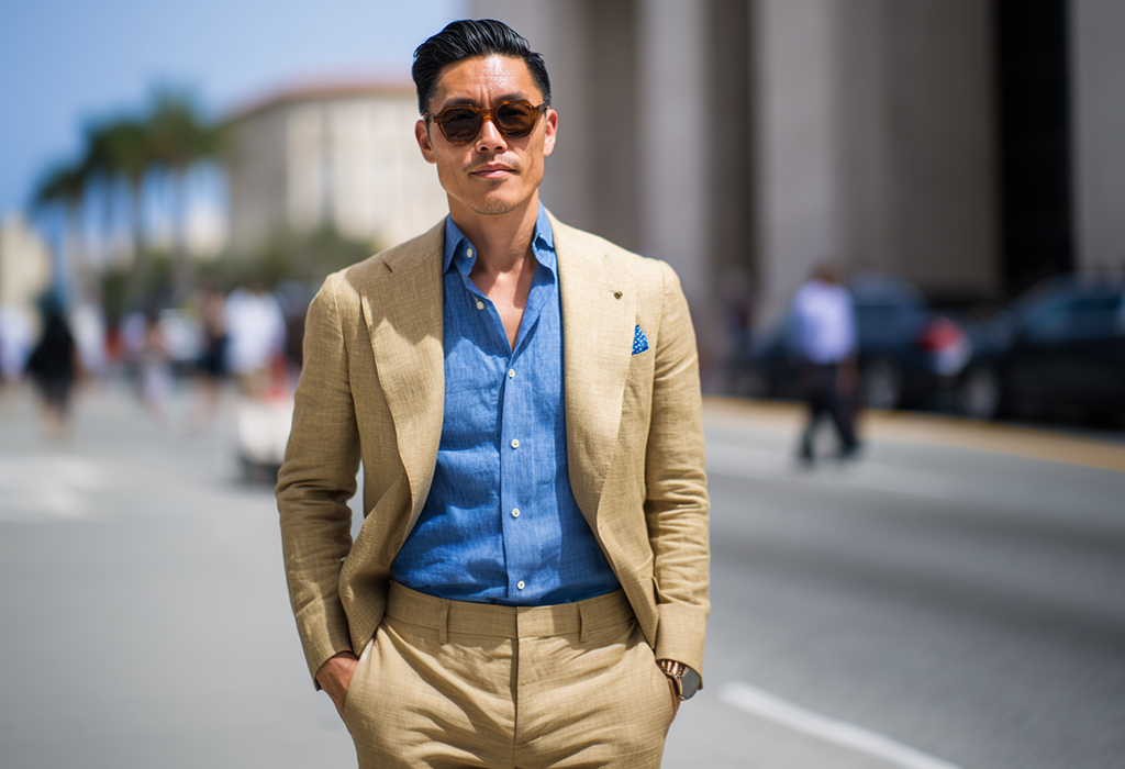 man wearing a medium blue chambray shirt with a tan linen suit