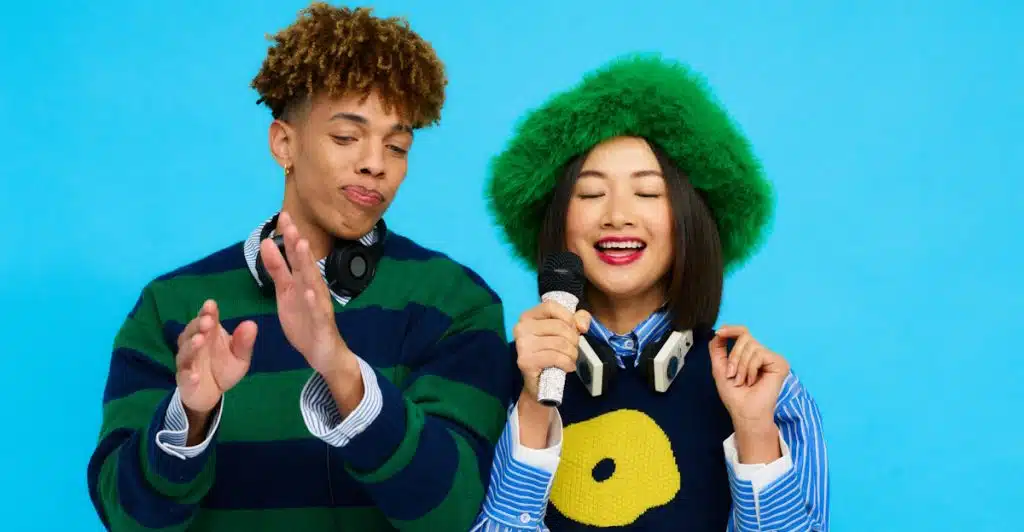 Two people dressed up for a themed karaoke night.