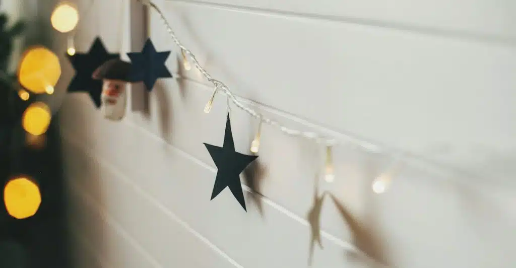 Wall decorated with string lights and star cutouts.