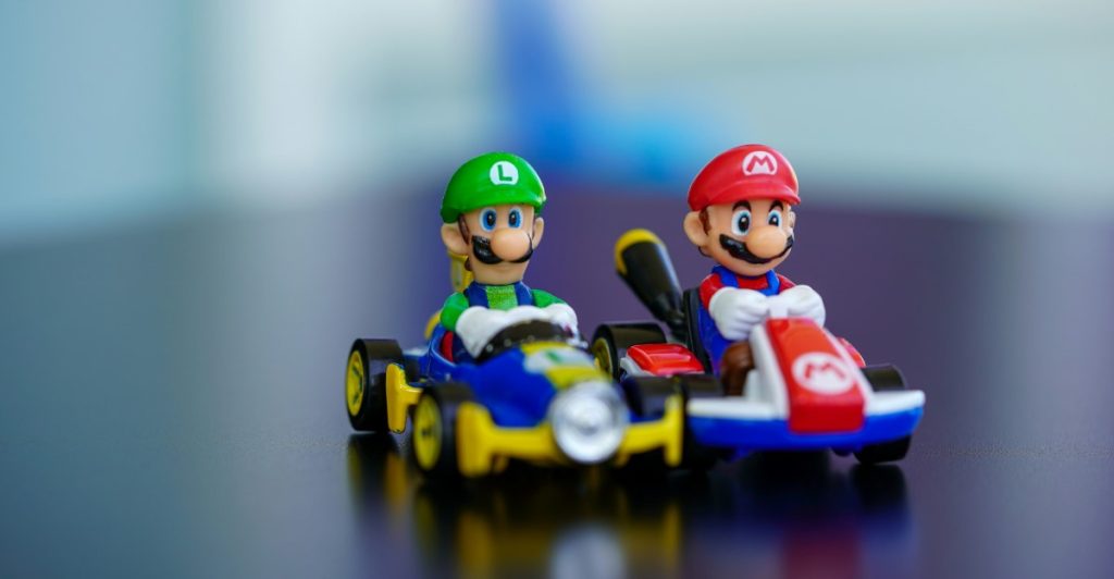 Two Super Mario Bros. characters, Mario and Luigi, in their go-karts as small figurines.