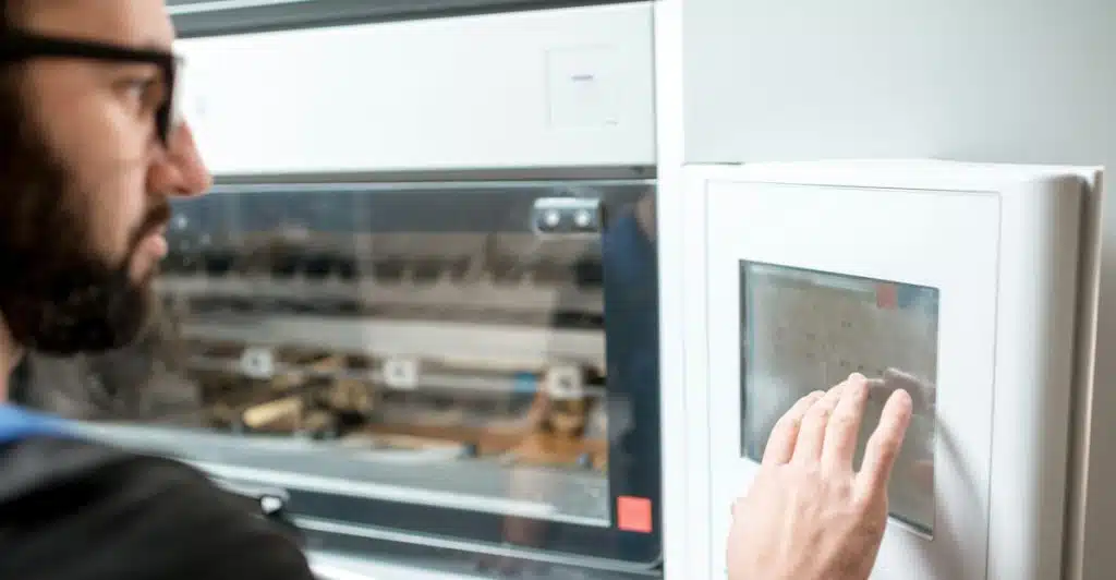 A person viewing and touching a touchscreen control panel on an oven.