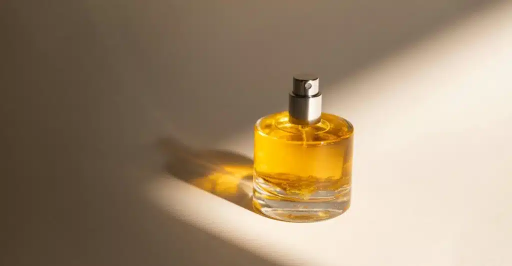 A Le Labo Santal 33 fragrance bottle on a surface with a shadow cast across it.
