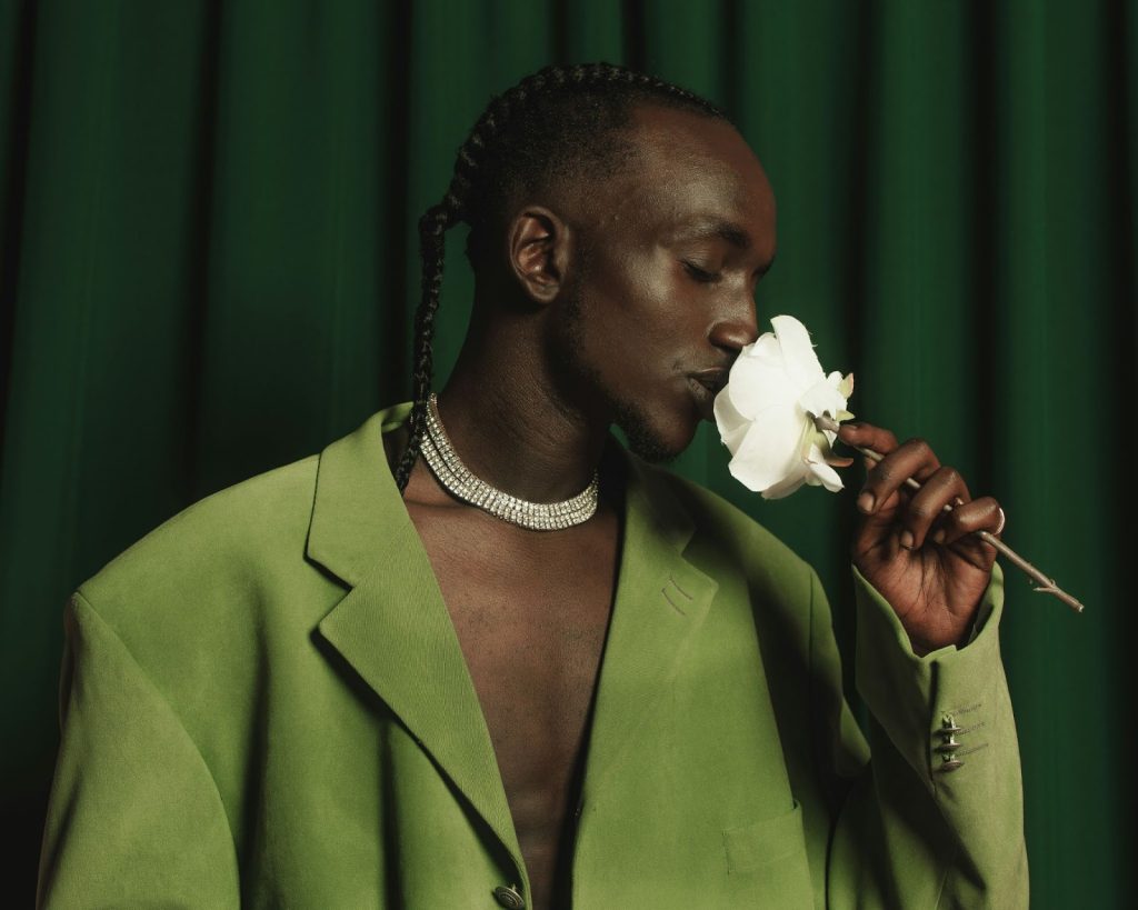 A man smelling the fragrance of flower.