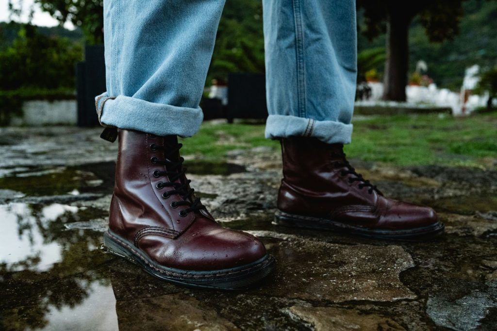 A man wearing boots on a rainy day.