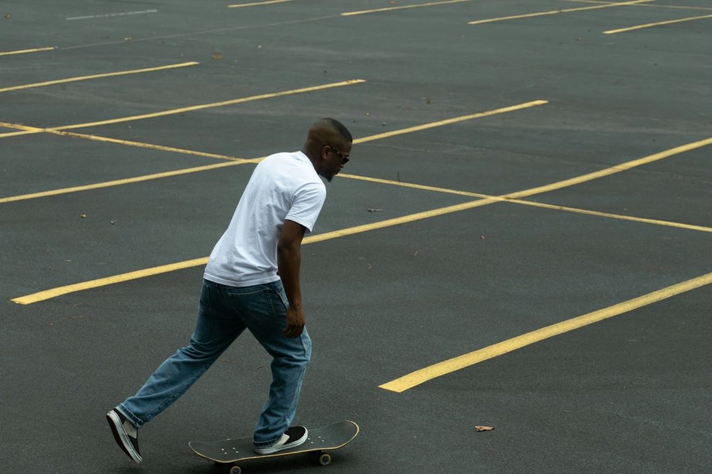 A man wearing a White Crew-Neck Tee.