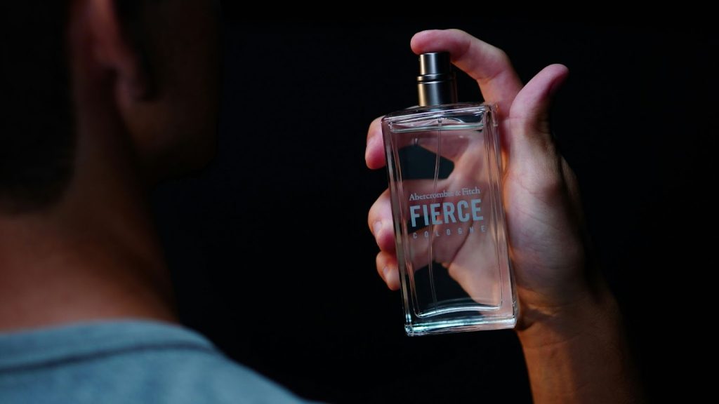 A man spraying his signature scent.