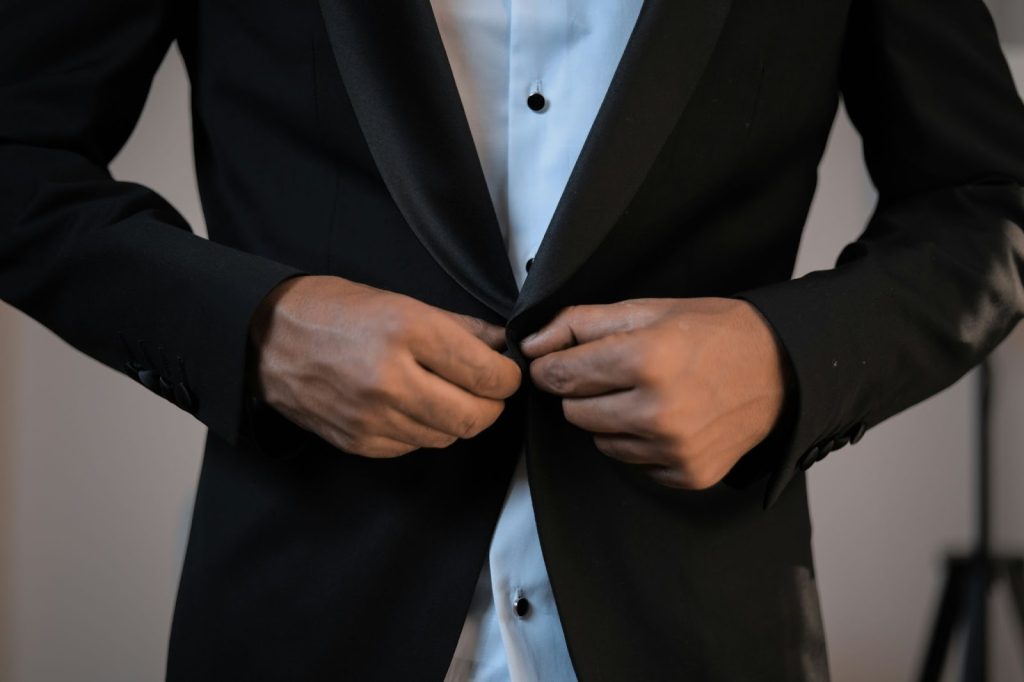 A man wearing a dark colored blazer.