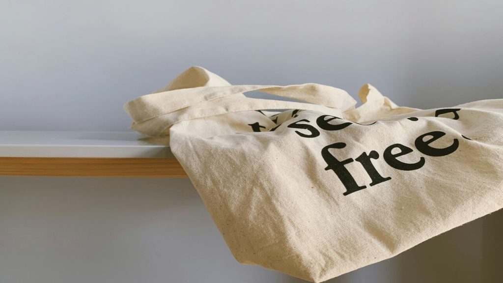 A canvas tote bag with the word “free”