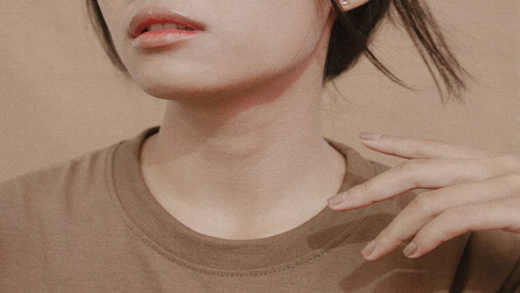 A woman wearing a brown shirt