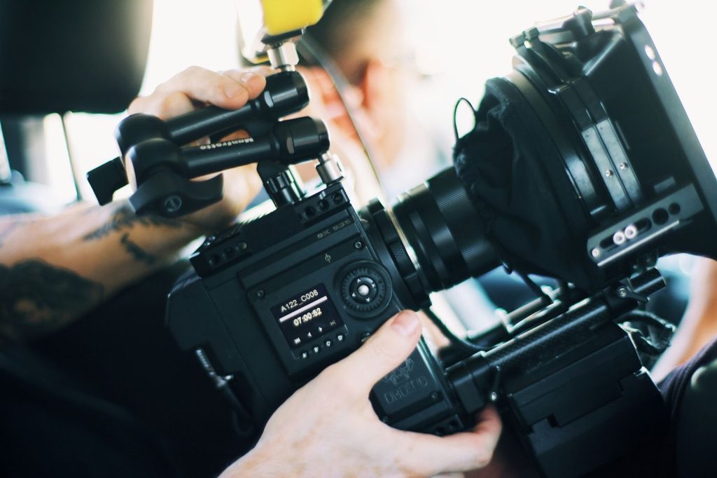A man holding a camera for movie