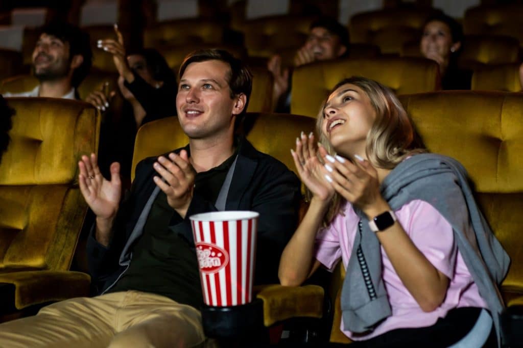 A man and woman clapping their hands