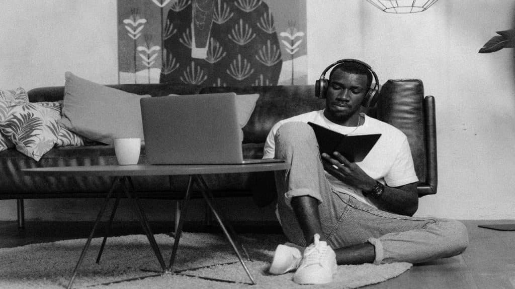 A man is studying or attending a virtual session in a calm, focused atmosphere.