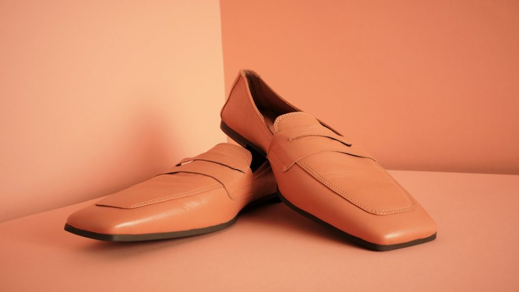 A pair of square, tan-colored dress shoes.