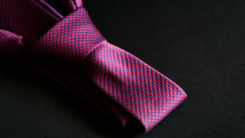 A close-up photo of a pink necktie.