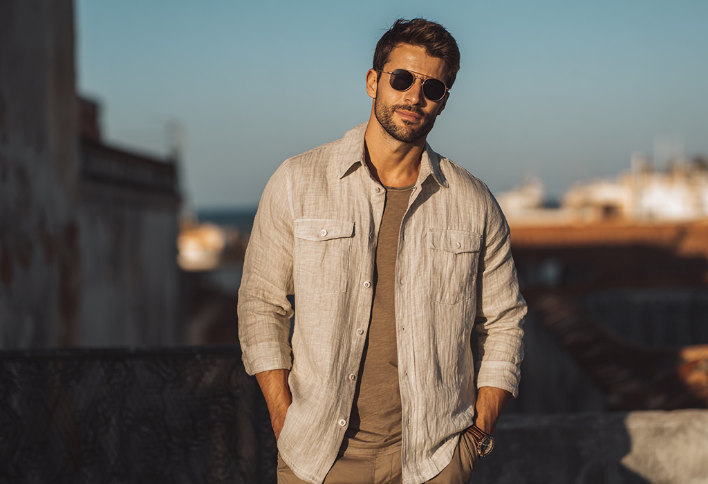 man wearing a beige linen overshirt over a brown T-shirt