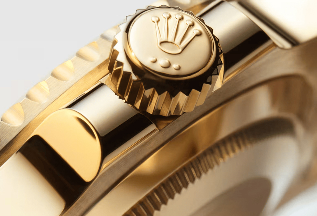 Close-up of Rolex Submariner gold crown and case detailing, highlighting luxury craftsmanship and signature Rolex design
