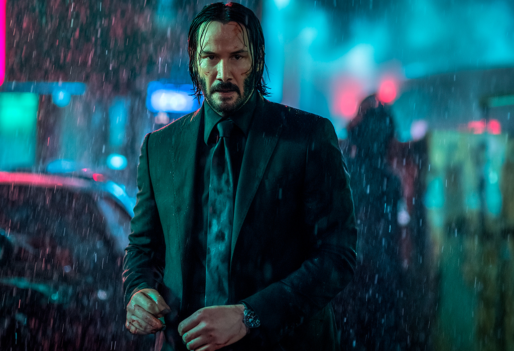 Keanu Reeves as John Wick wearing a Rolex Submariner in the rain, dressed in a black suit under neon lights—blending action, style, and luxury
