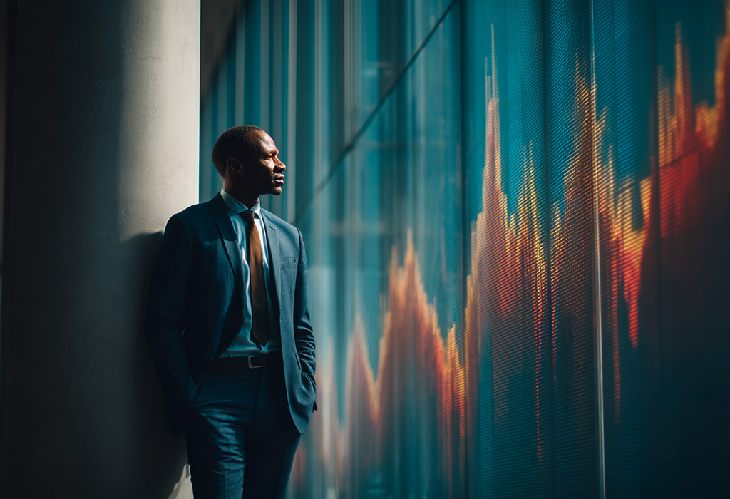 Stylish businessman watches volatile stock graph calmly.