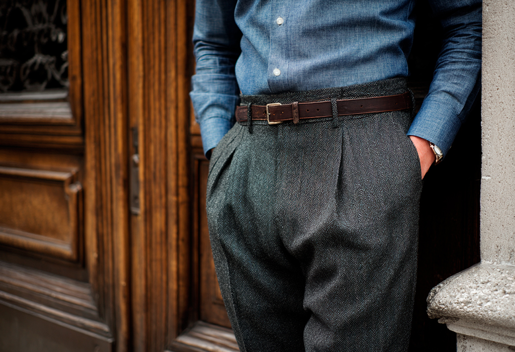 Grey pleated flannel trousers with leather belt