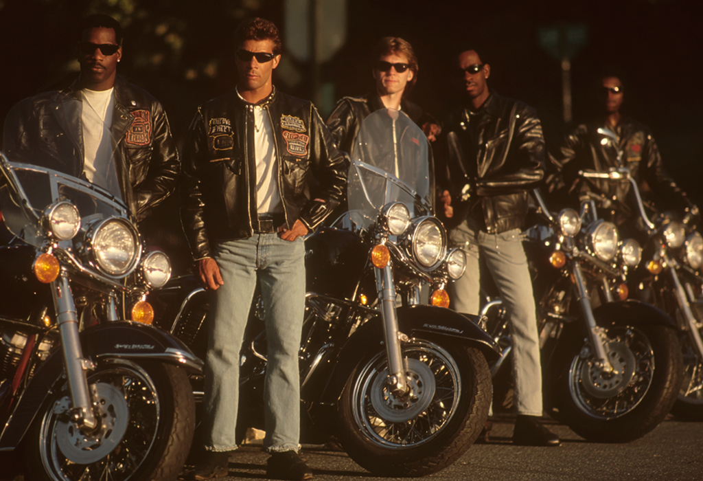 Group of bikers in leather jackets with Harleys