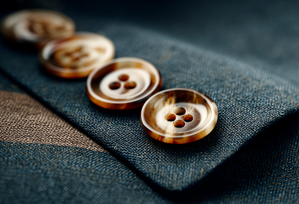 Detailed horn buttons sewn onto fine wool suit
