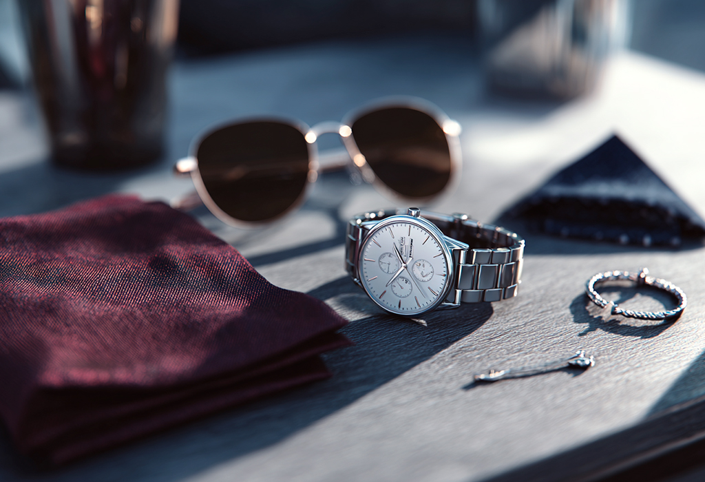 Luxury watch with accessories on textured table