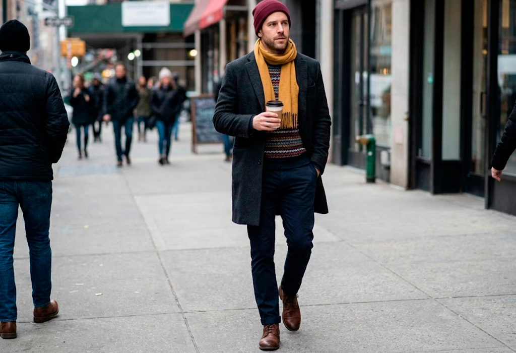 Common winter outfit mistake showing a dark overcoat worn with uncoordinated layers and clashing proportions.